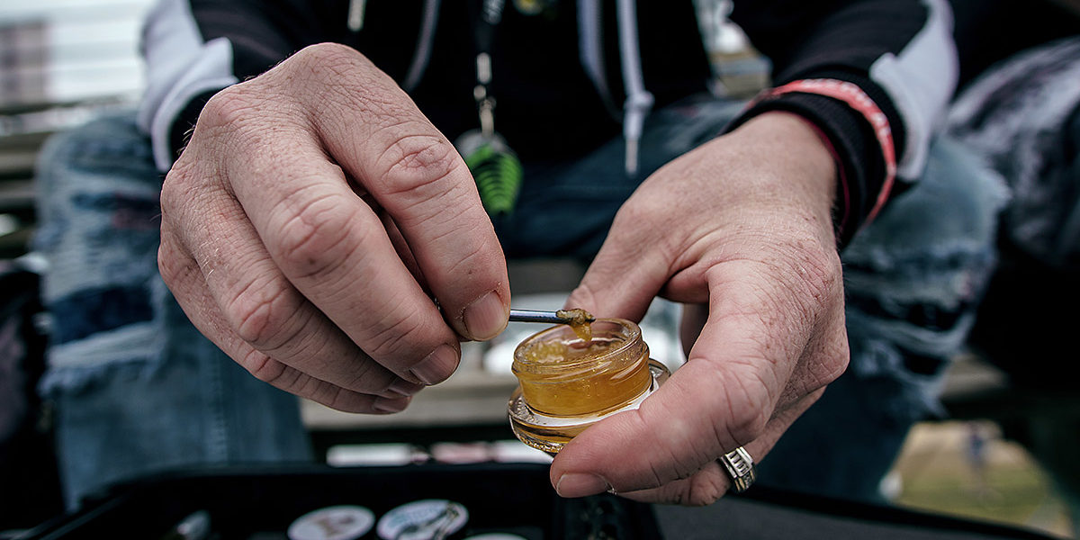 a man with a small container showing what are dabs