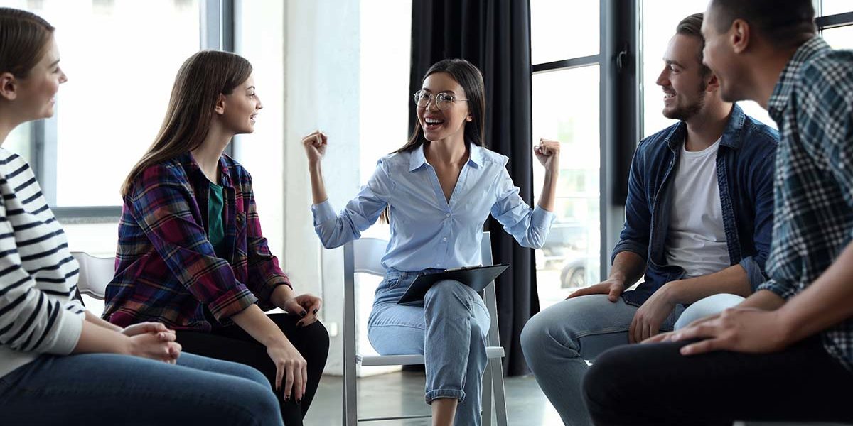 a group of people sit in group therapy at a heroin rehab center atlanta ga