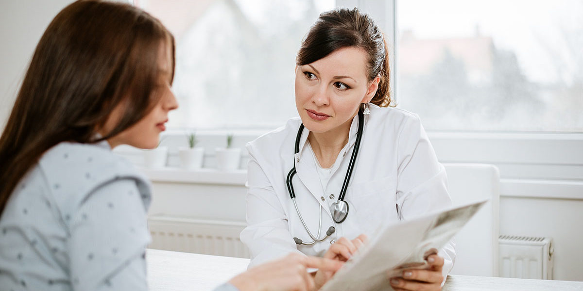 a doctor explaining the results of an Abuse Assessment to a patient
