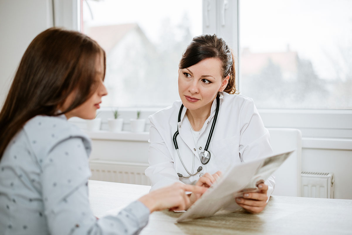 a doctor explaining the results of an Abuse Assessment to a patient