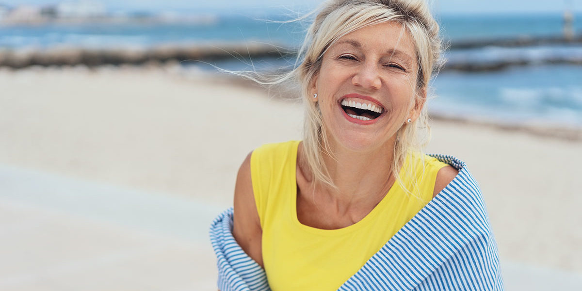 a woman smiling during a walk during Beach Rehab