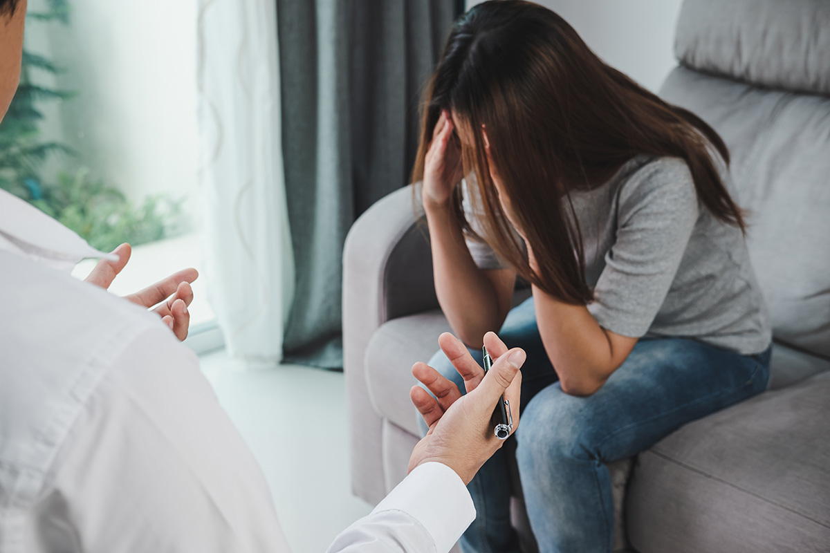 substance abuse counselor talking to crying patient