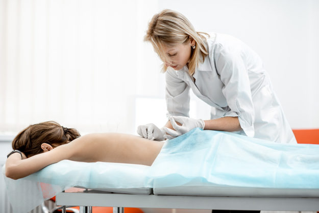 woman receiving acupuncture therapy