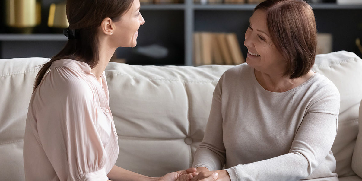 mom holding daughters hands happy with addiction recovery care