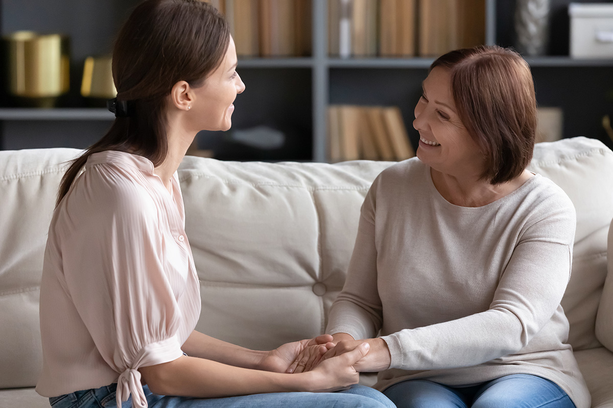 mom holding daughters hands happy with addiction recovery care