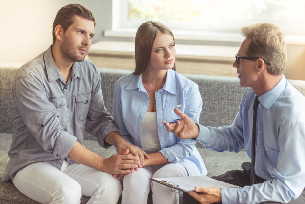 man and wife holding hands in Couples Addiction Therapy