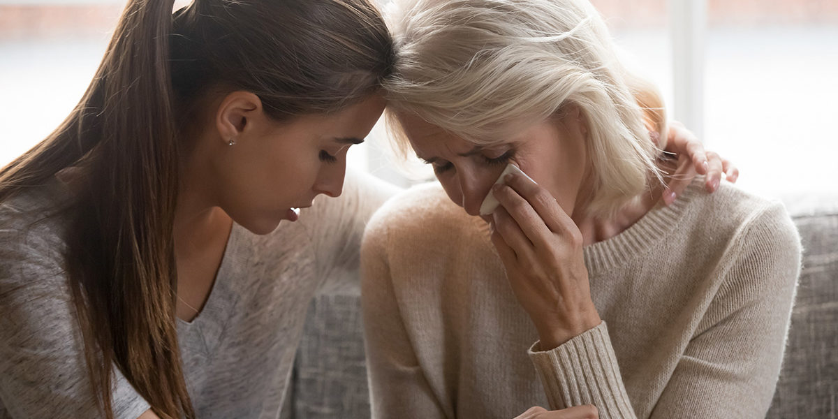 woman comforting another crying during Grief and Loss Counseling