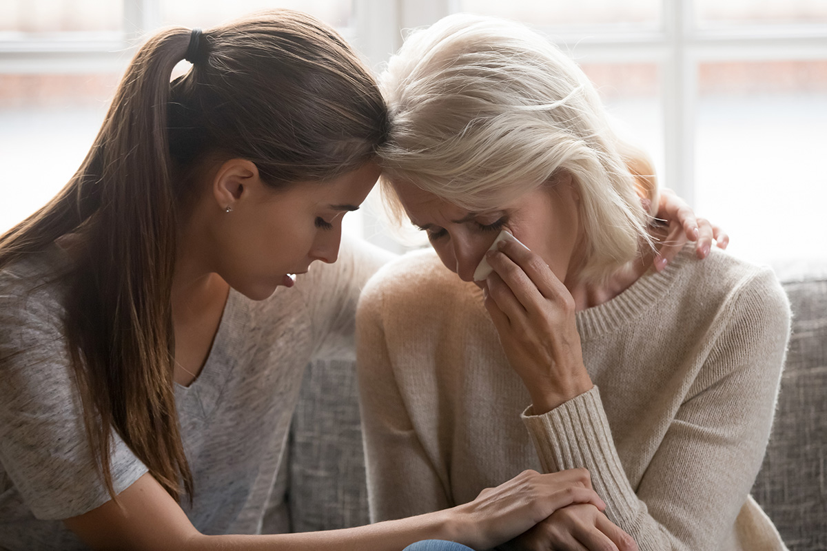 woman comforting another crying during Grief and Loss Counseling