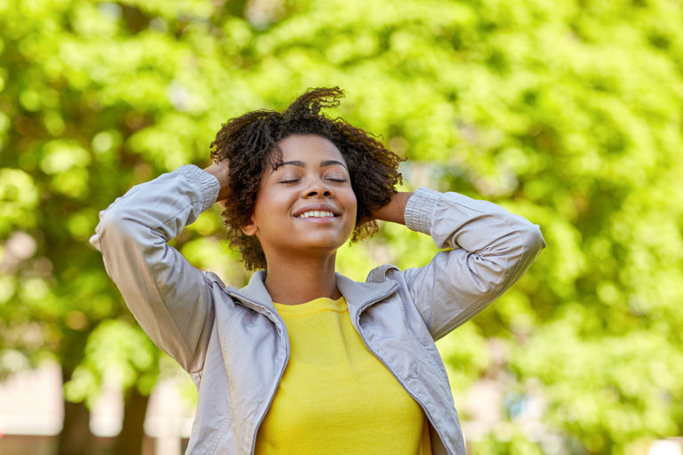 woman adjusting her hair during Mindfulness Based Relapse Prevention in the park