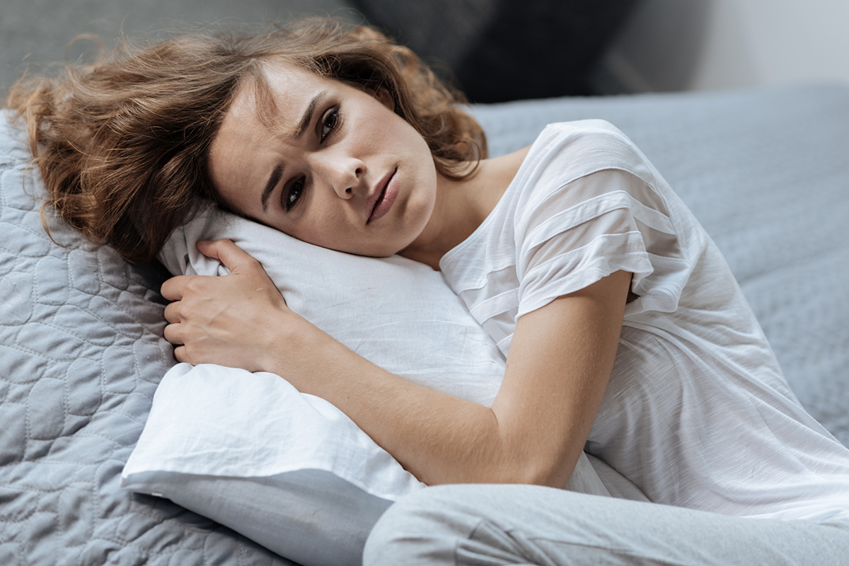 woman hugging pillow struggling with Post Acute Withdrawal Syndrome