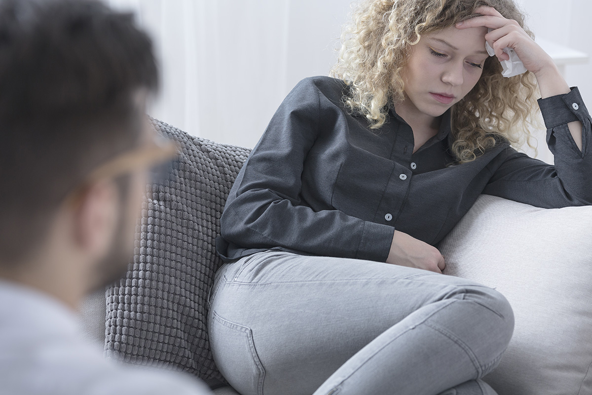 woman crying during Rational Emotive Behavior Therapy