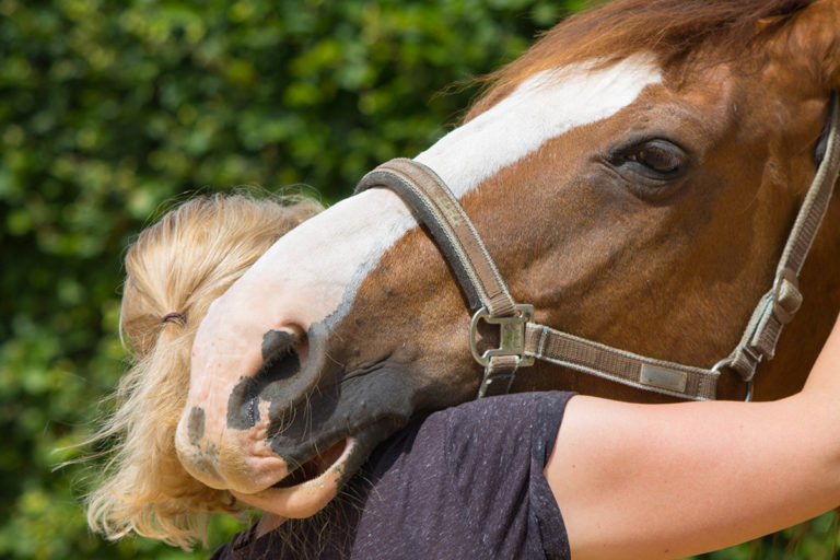 woman enjoying equine therapy as one of the Types of Psychotherapy Used in Addiction Treatment