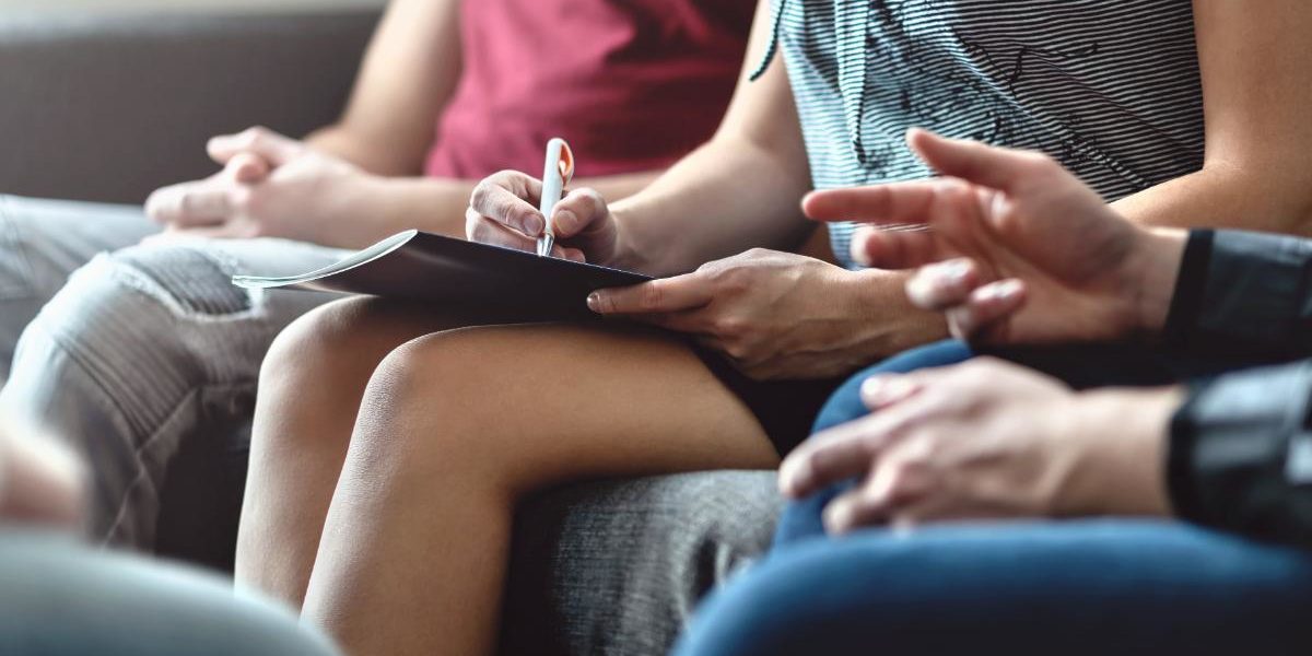 people at a meeting - hands only showing